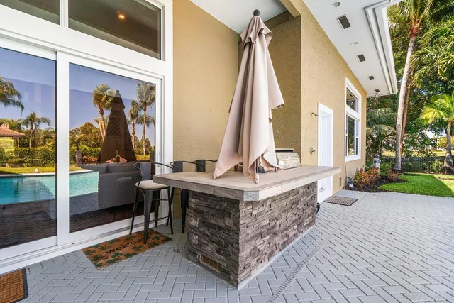 a view of swimming pool with lawn chairs and a yard