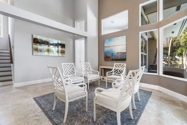 a kitchen with stainless steel appliances a refrigerator a sink dishwasher a stove and white cabinets with wooden floor