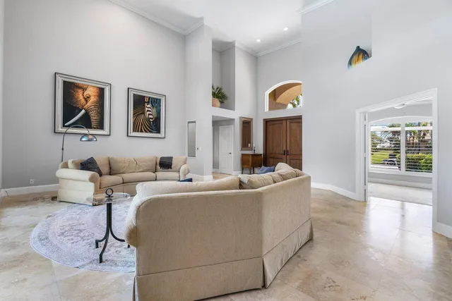 a view of a dining room with furniture a chandelier and wooden floor