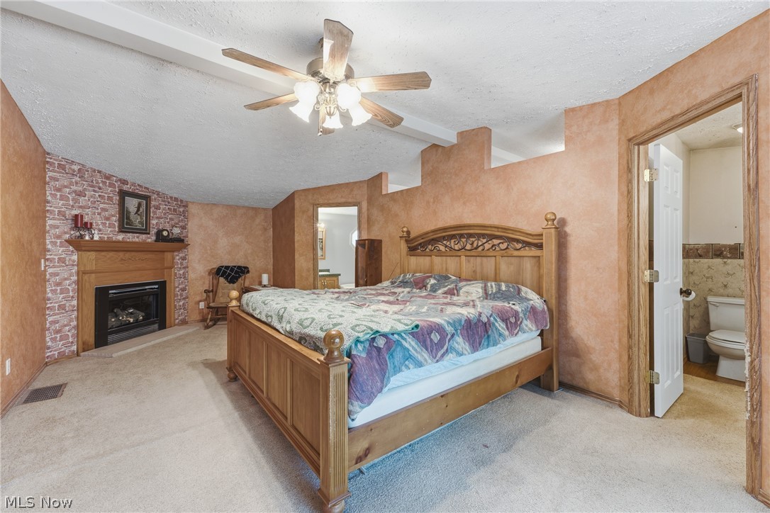 6828 Angling Road Wooster, OH 44691 - Photo 17 of 43 Carpeted room featuring a brick-accented fireplace with a wood mantel