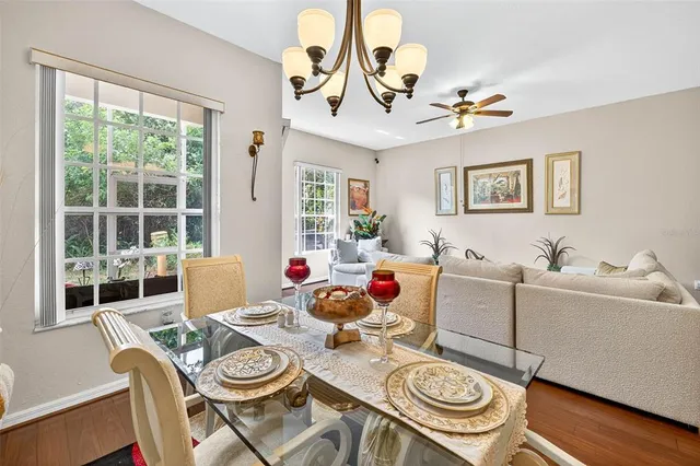 a living room with furniture a chandelier and a window