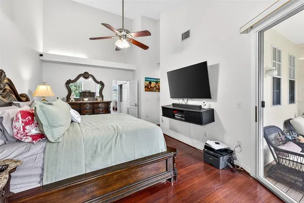 a bedroom with furniture and a flat screen tv