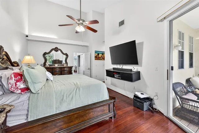 a bedroom with furniture and a flat screen tv