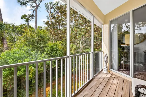 a view of a balcony with wooden floor