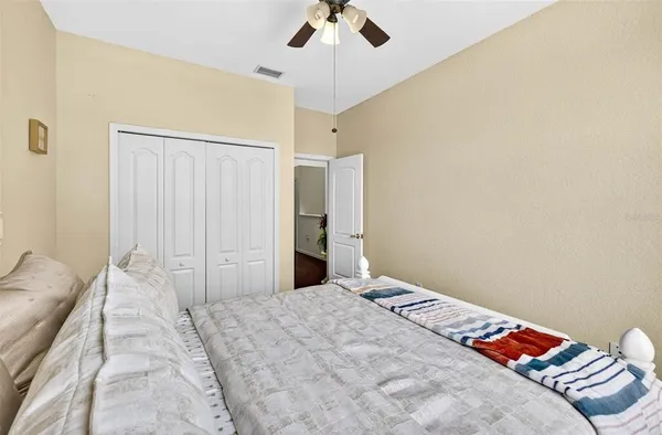 a bedroom with a bed and a chandelier