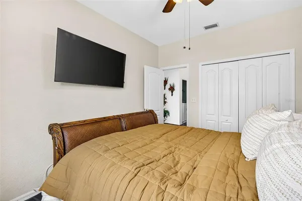 a bedroom with a bed and a flat screen tv