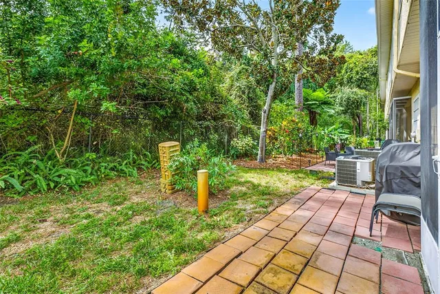 a view of a house with a yard and sitting area