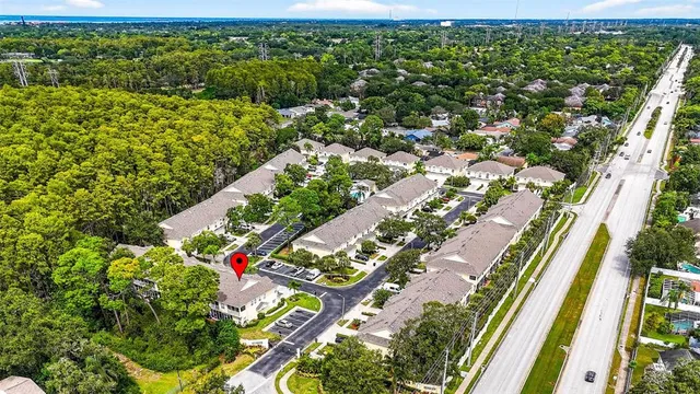 an aerial view of a houses with a yard