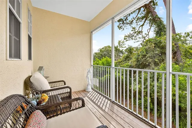 a view of a balcony with chair and wooden floor