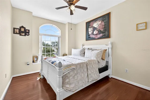 a large bed sitting in a bedroom next to a window