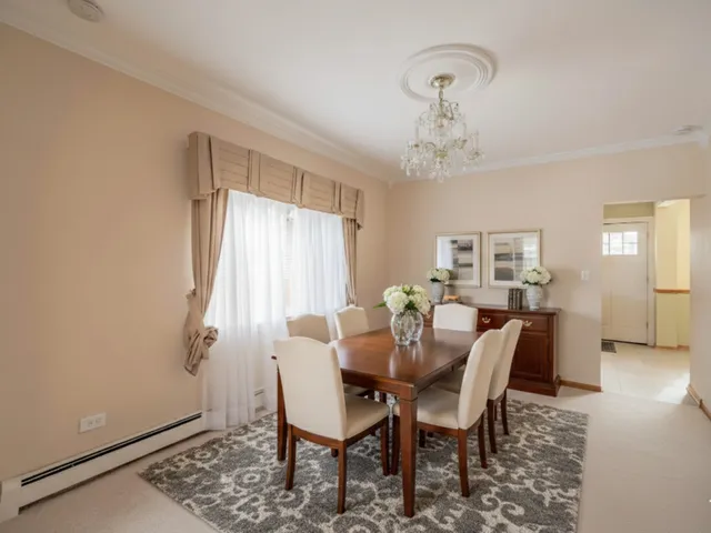 a view of a kitchen with a white cabinets and wooden floor