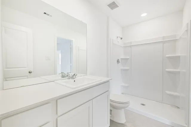 a bedroom with a bed lamp and a large window