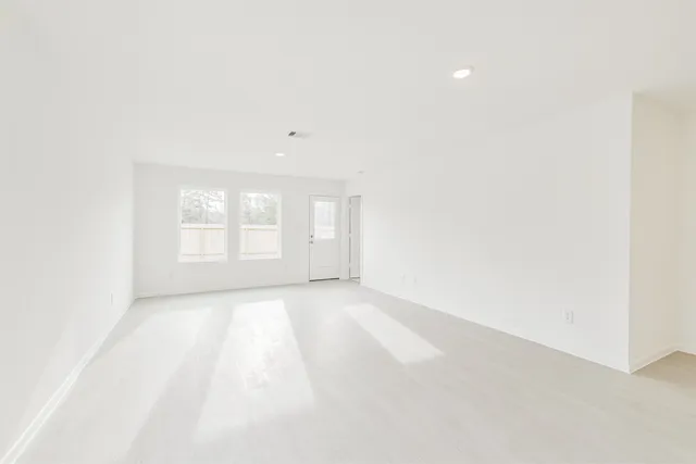 a kitchen with granite countertop a sink stainless steel appliances and white cabinets
