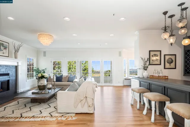 a living room with fireplace furniture and a wooden floor