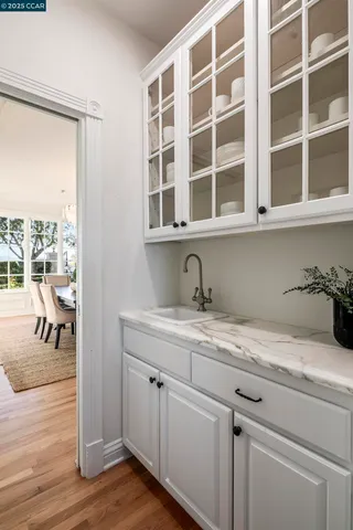 a hallway with sink and wooden floor