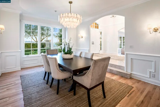 a view of a dining room with furniture wooden floor and chandelier