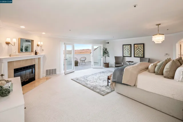 a spacious bedroom with a large bed and a fireplace