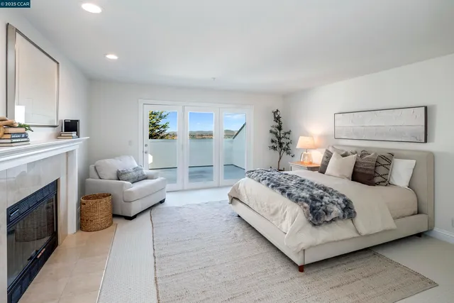 a spacious bedroom with a bed and a fireplace