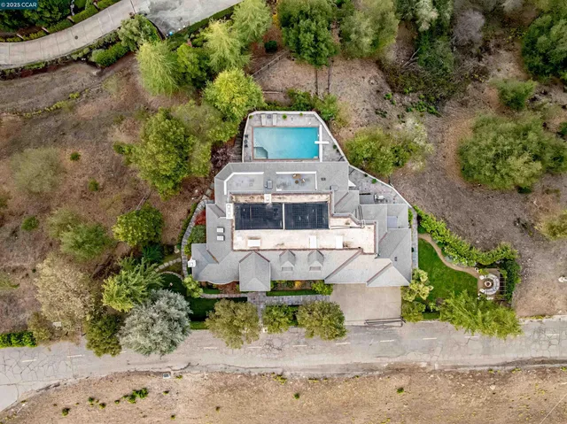an aerial view of a house with a yard