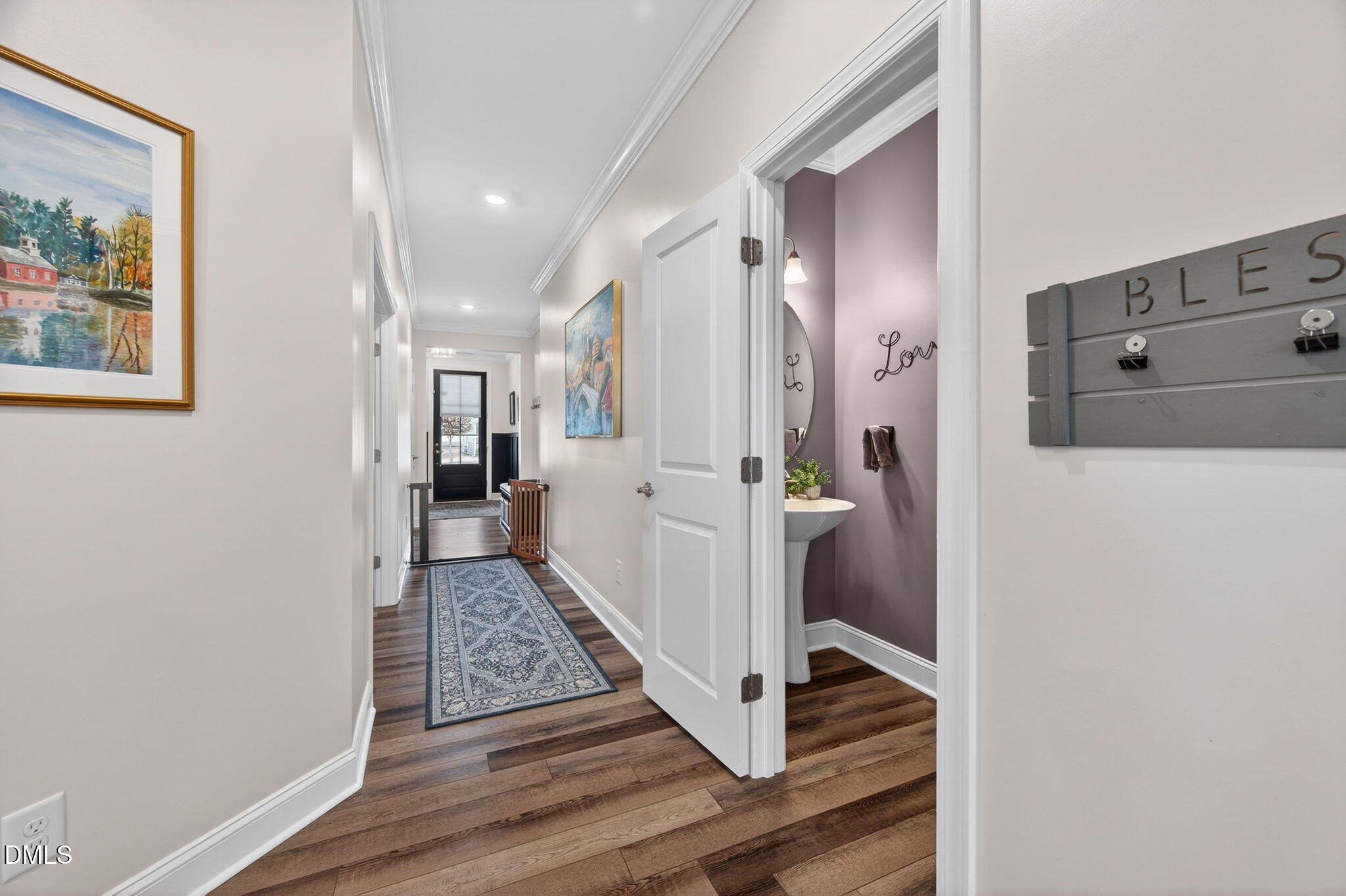 118 Mahogany Raleigh, NC 27610 - Photo 4 of 74 a view of a hallway with wooden floor and staircase