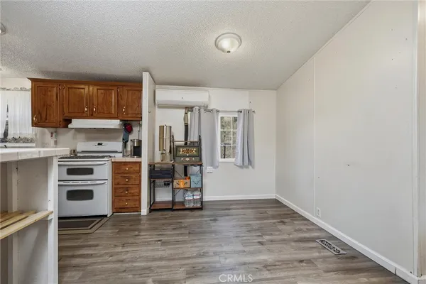 a kitchen with a sink a refrigerator and cabinets