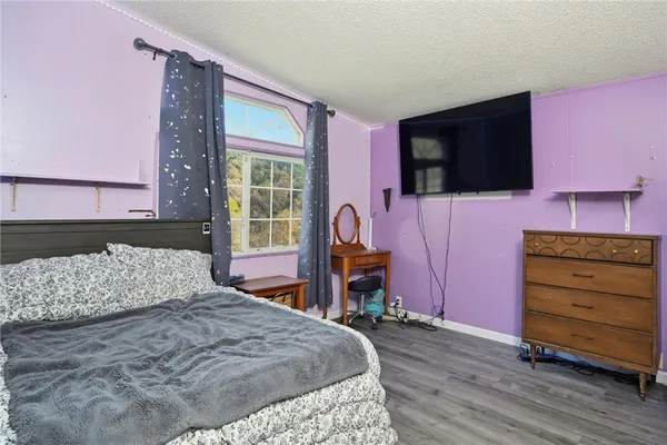 a bed sitting in a bedroom next to a window