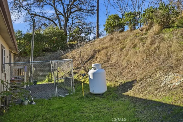 a view of a house with a backyard