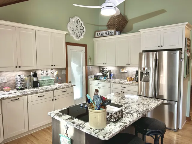 a kitchen with a refrigerator and a stove top oven