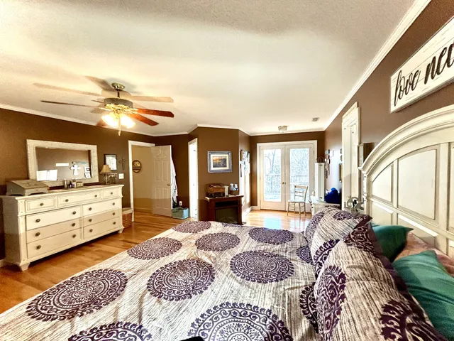 a large bedroom with a large bed and a chandelier