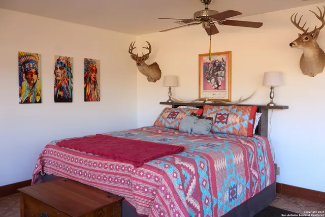 a bedroom with a bed and painting on the wall