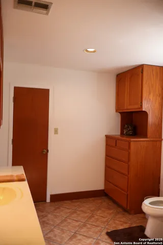 a room with a bench and cabinets