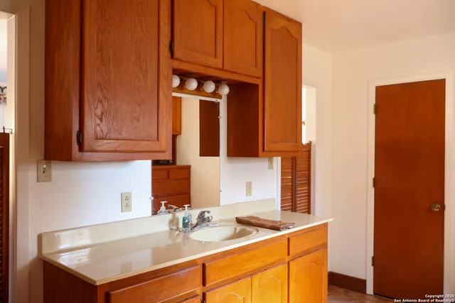 a kitchen with stainless steel appliances granite countertop a sink and cabinets