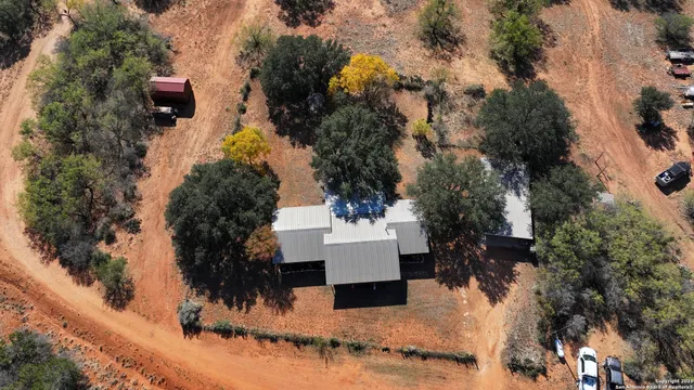 an aerial view of a house with a yard
