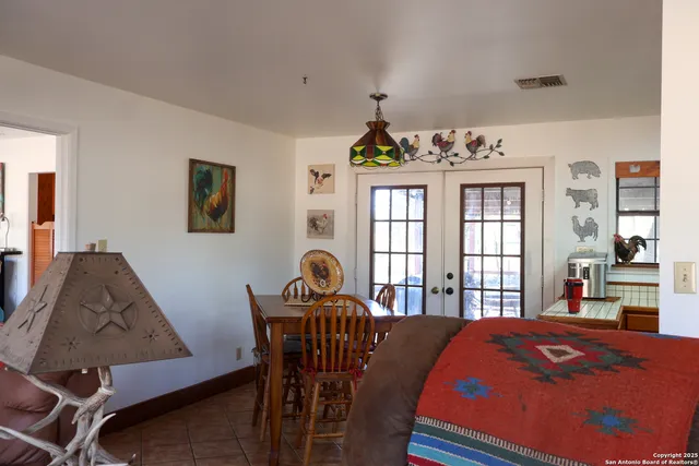 a bed room with a bed window and table chair