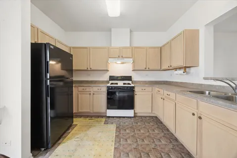 a kitchen with granite countertop white cabinets and stainless steel appliances