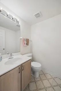 a bathroom with a sink a toilet and mirror