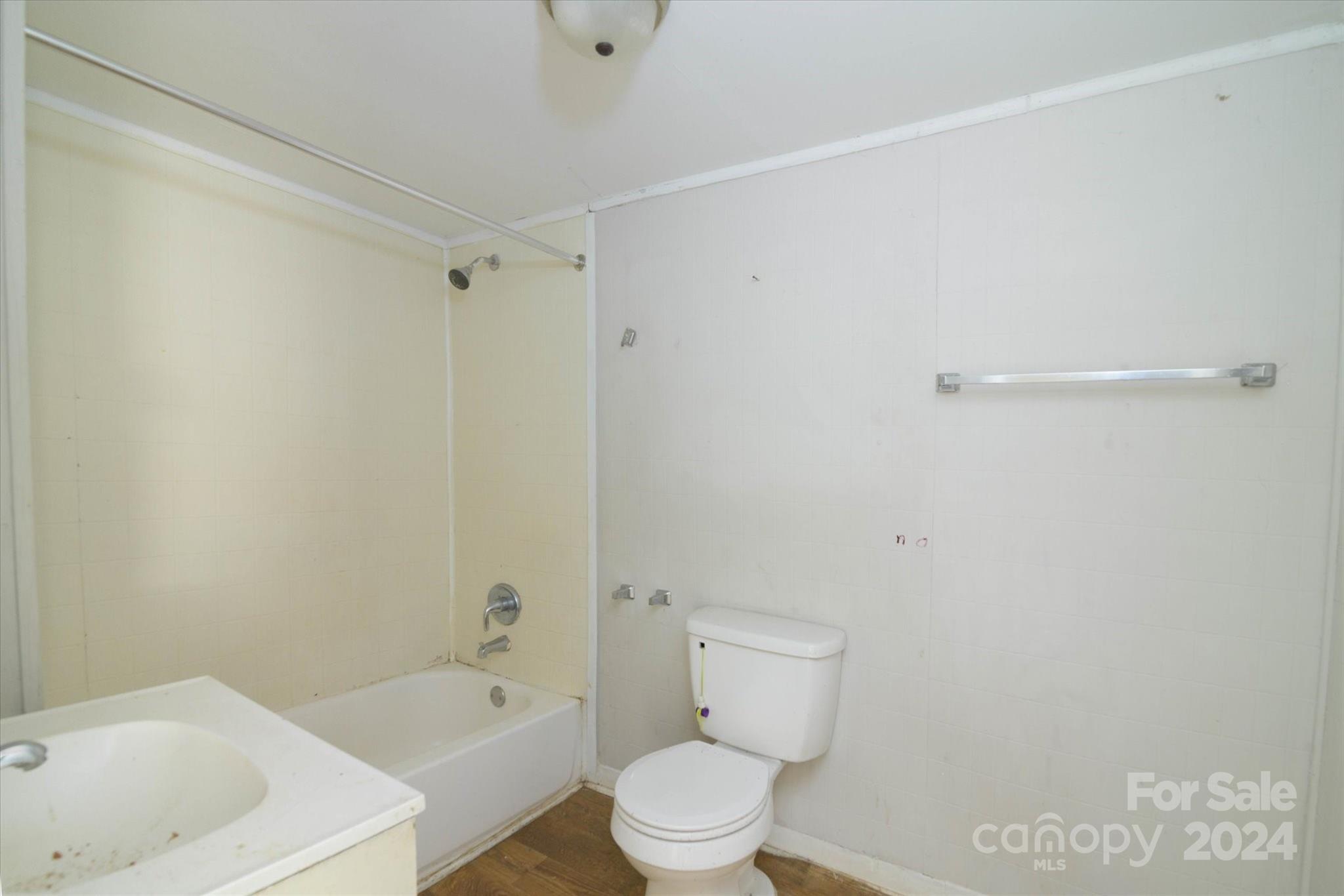 802 South Hoskins Road Charlotte, NC 28208 - Photo 13 of 15 a white toilet sitting next to a bath tub