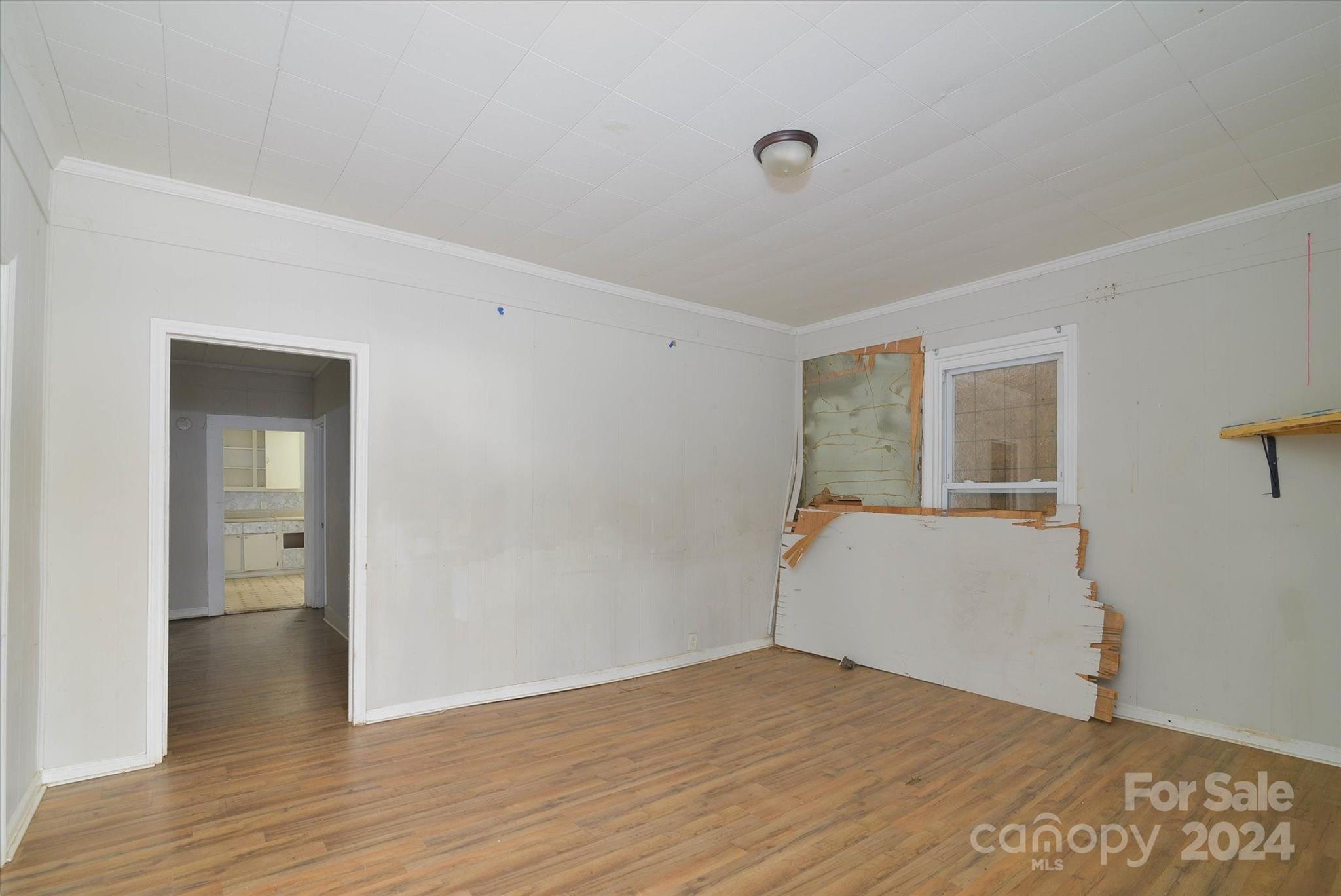 802 South Hoskins Road Charlotte, NC 28208 - Photo 8 of 15 a view of an empty room with wooden floor and a window