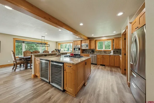 a kitchen with stainless steel appliances granite countertop a stove and a refrigerator
