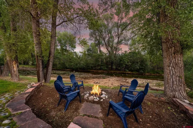 a view of a lake with outdoor seating