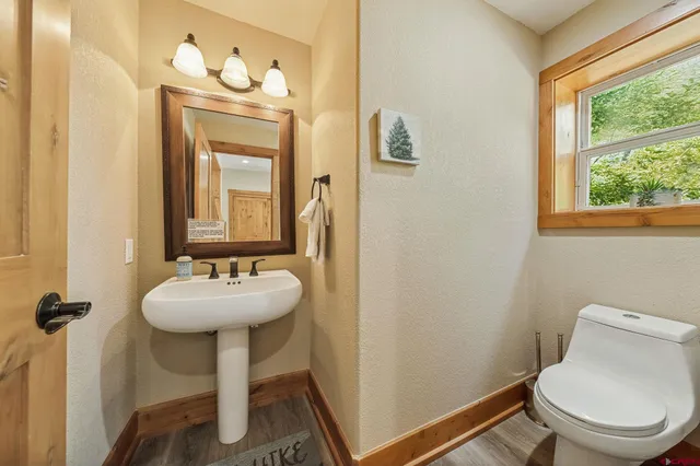 a bathroom with a toilet sink and mirror