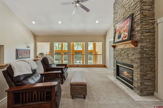 a living room with furniture fireplace and flat screen tv
