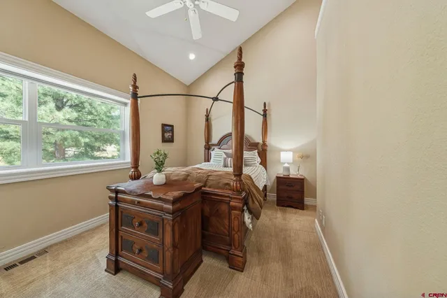 a bed sitting in a room next to a window