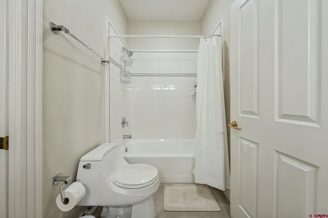 a bathroom with a toilet and shower