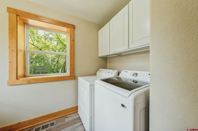 a utility room with sink dryer and washer