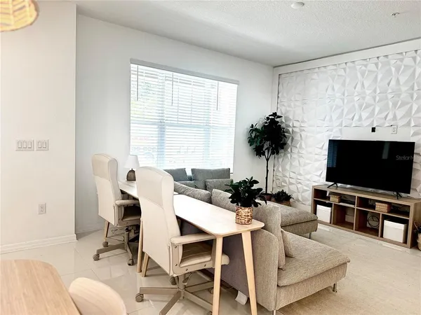 a view of a livingroom with furniture and a flat screen tv