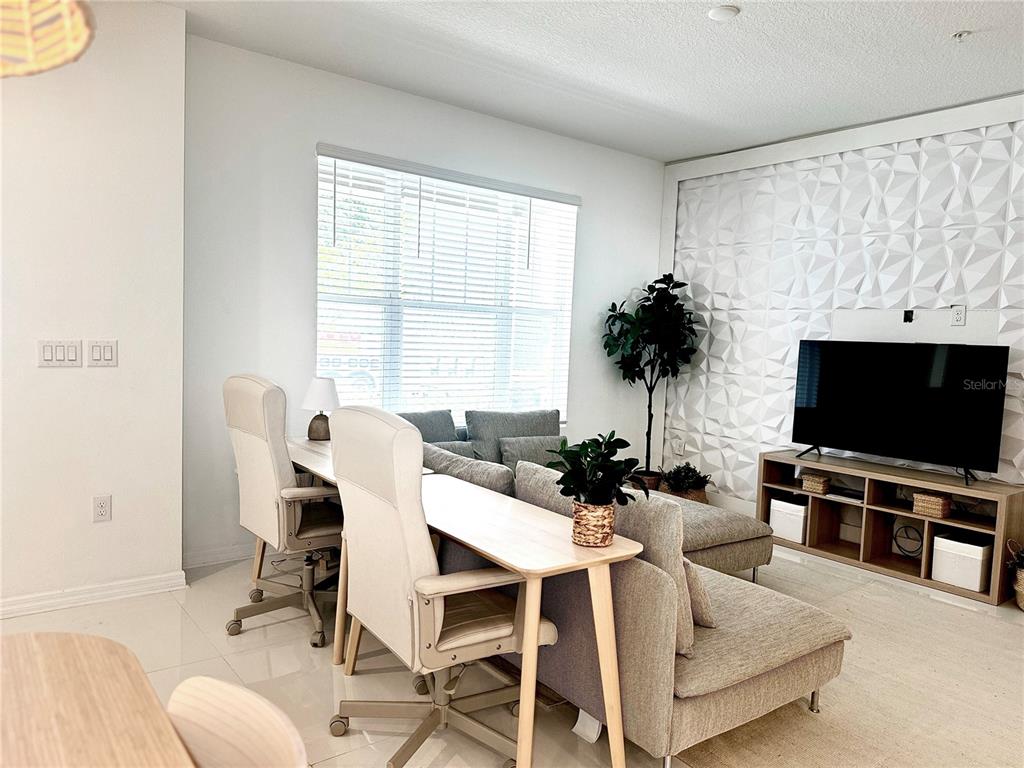 10251 Highline Crest Street Orlando, FL 32832 - Photo 11 of 35 a view of a livingroom with furniture and a flat screen tv