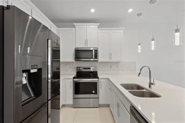 a kitchen with a sink and stainless steel appliances
