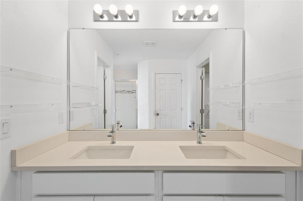 10251 Highline Crest Street Orlando, FL 32832 - Photo 23 of 35 a bathroom with a sink and a mirror
