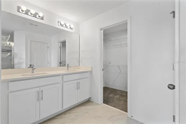 a bathroom with a double vanity sink and mirror